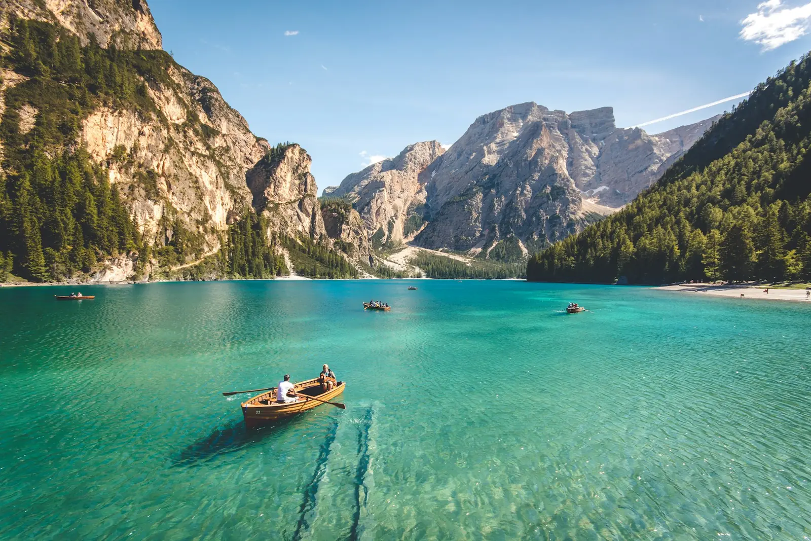 A calm alpine lake with peaks behind it