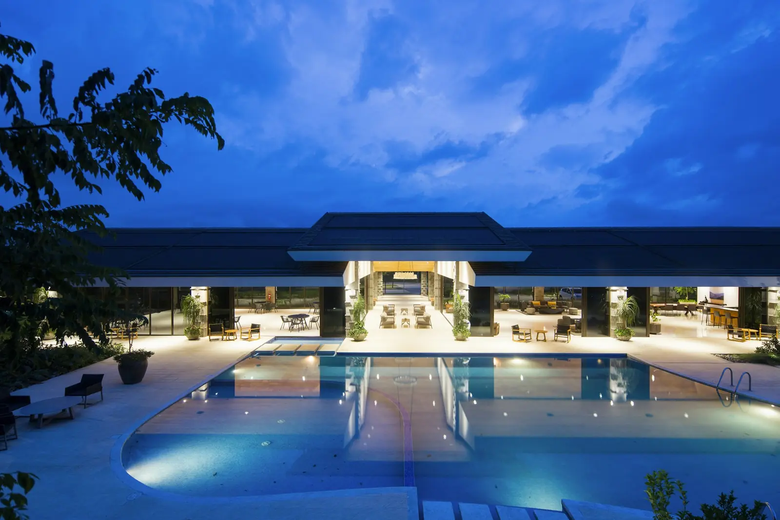 A hotel pool courtyard lit at dusk