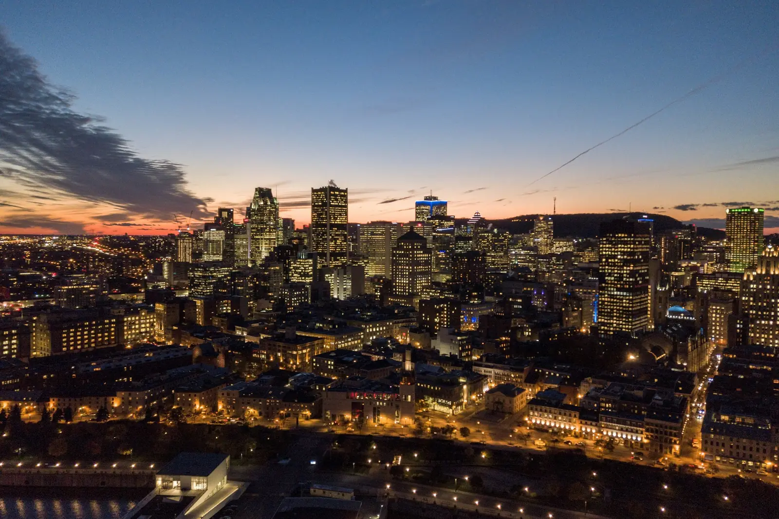 Downtown Montréal at dusk, with Mount Royal on the horizon