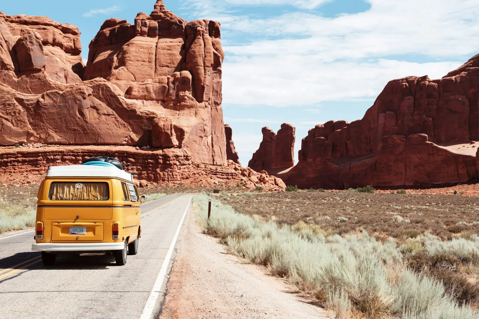 An open highway running toward a flat horizon