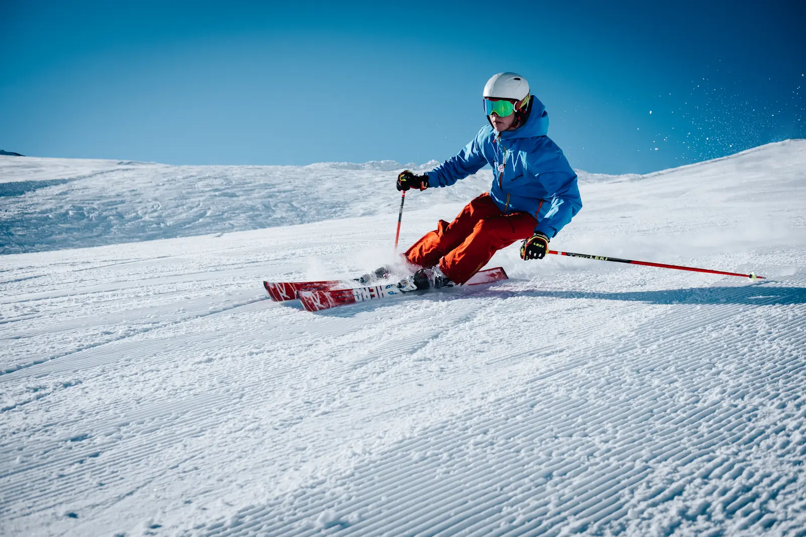 A skier descending a steep snowy slope