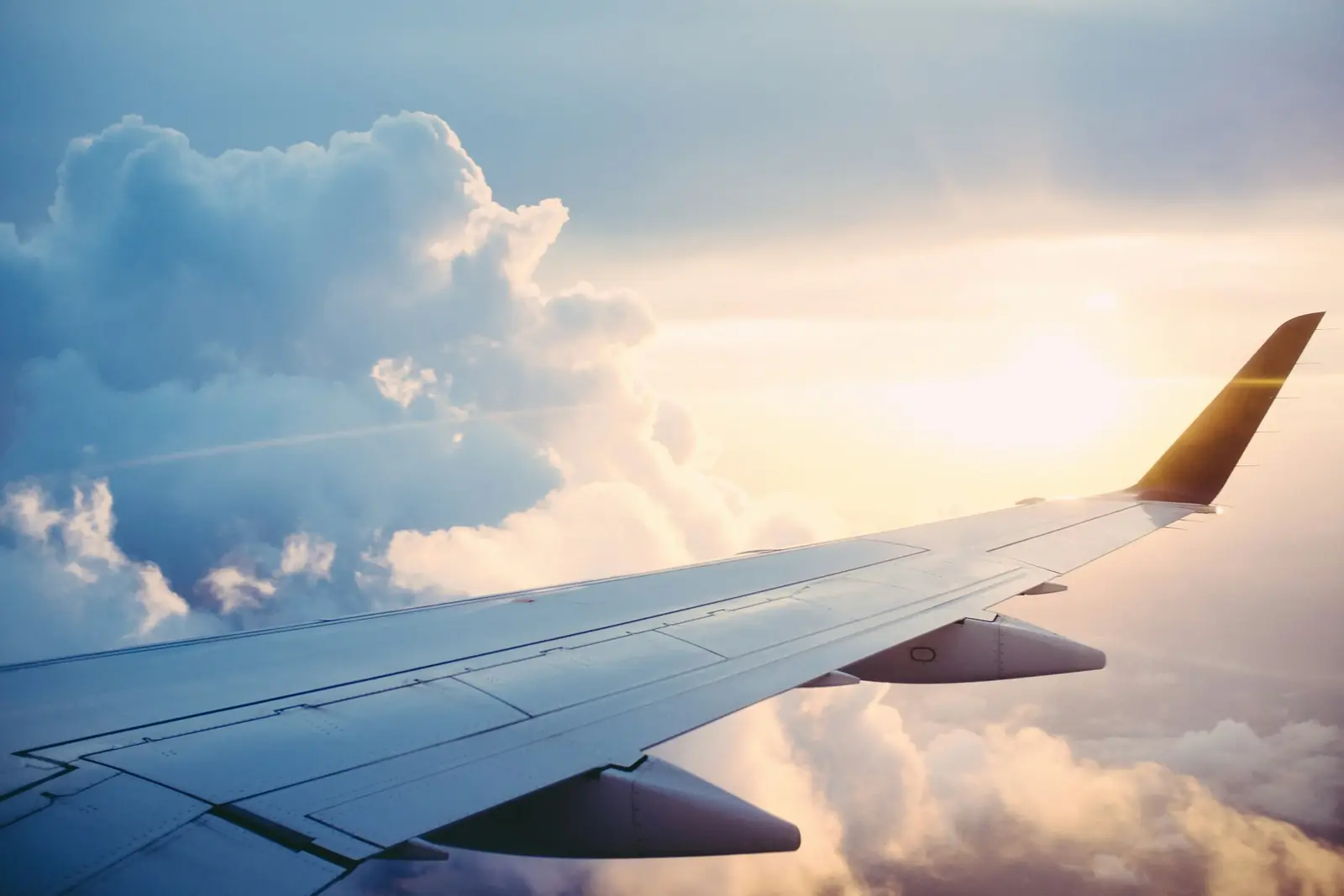 An aircraft wing above a layer of cloud